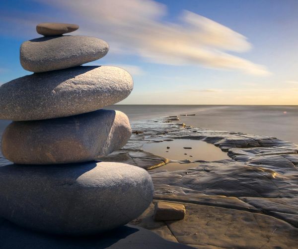 Balanced stones on a serene background, symbolizing stability and calm.