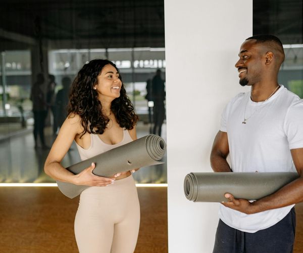 Group of men talking and smiling after a workout.