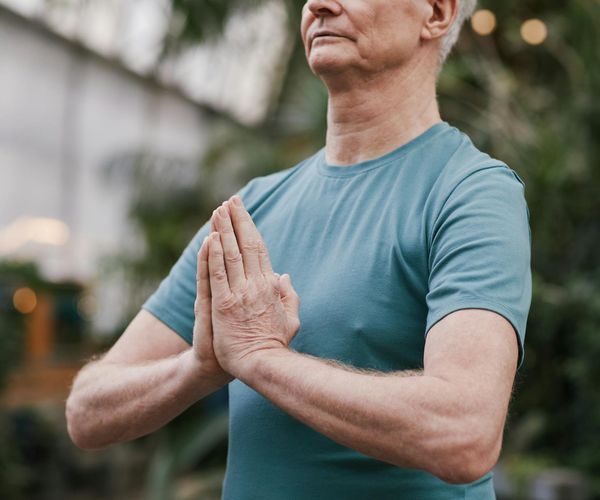 Man meditating peacefully after a workout session, feeling calm.